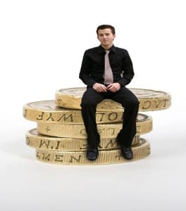 business man sitting on coins